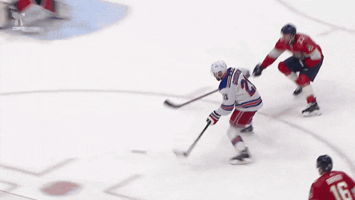 a hockey player with the number 23 on his jersey is skating on the ice