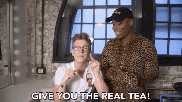 two men are standing next to each other and one of them is saying give you the real tea !
