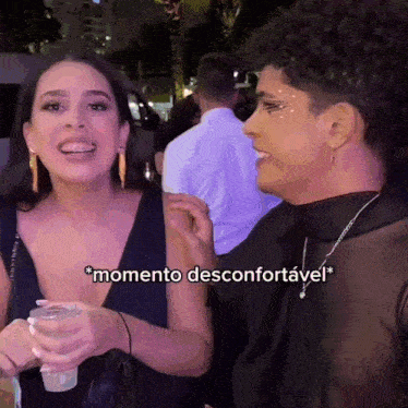 two women are talking to each other and one of them is holding a glass of water .