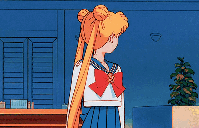 a girl in a sailor suit has a red bow on her bow tie