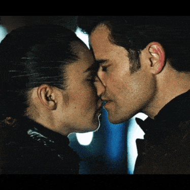 a man and a woman are kissing each other