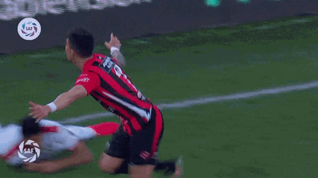 a soccer player with the number 7 on his jersey is kneeling on the field