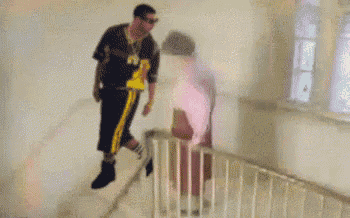 a person wearing striped socks and black boots is walking down stairs .