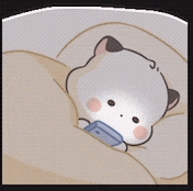 a cartoon cat is laying on a bed with a blanket and a blue shirt on .
