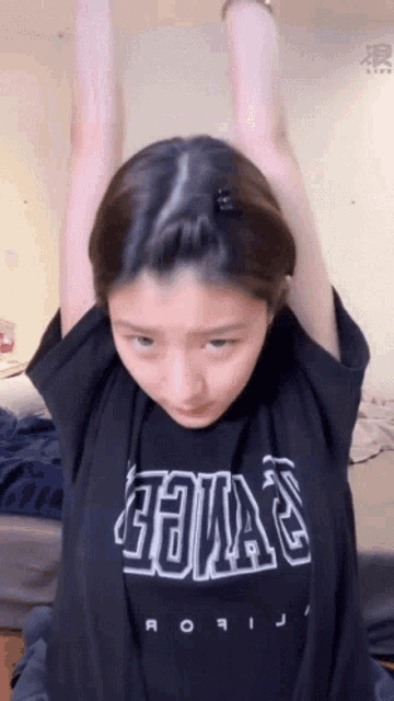 a girl wearing a black shirt that says ' aoi ' on it