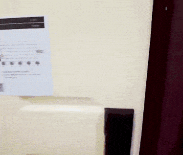 a door is open to a room that has a light switch on the wall
