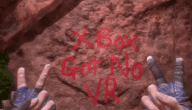 someone has written xbox got no vr on a rock with their hands