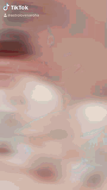 a tiktok video of a man sitting at a table smiling and laughing