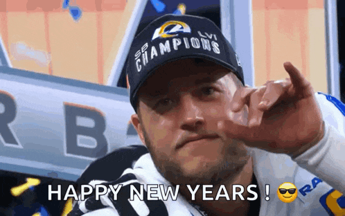 a man wearing a hat that says champions is giving the middle finger