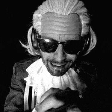 a man with a wig on his head and sunglasses