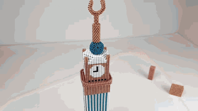 a bunch of black beads are stacked on top of each other on a table