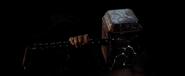 a woman in a mask holds a hammer in her hand