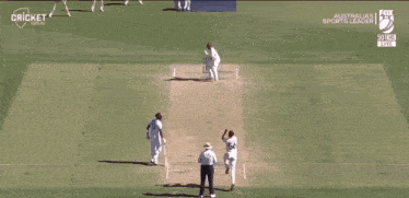 a man in a white cricket shirt is pointing up at the sky