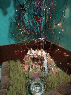 a christmas nativity scene with a tree and decorations