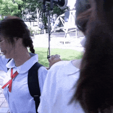 a girl wearing a white shirt and a red tie