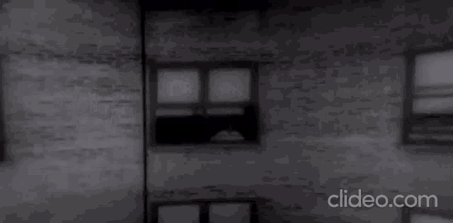 a black and white photo of a brick wall with the url clideo.com
