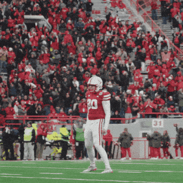 a football player with the number 30 on his jersey stands on a field
