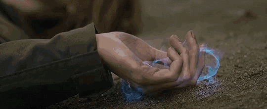 a person is laying on the ground holding something in their hand .