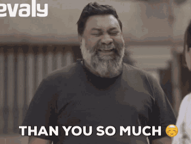 a man with a beard is smiling and says than you so much