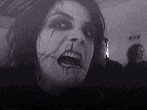 a black and white photo of a woman with a broken face and blood on her face .