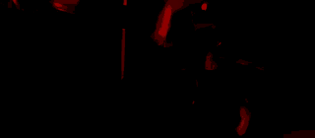 a red light is shining on a person 's face