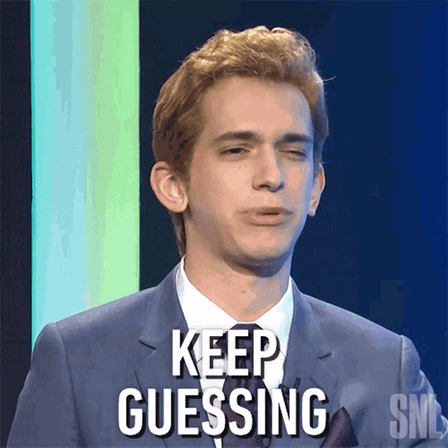 a man in a suit says keep guessing on the screen