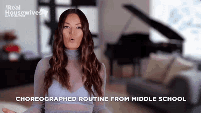 a woman in a blue top is talking about her choreographed routine from middle school