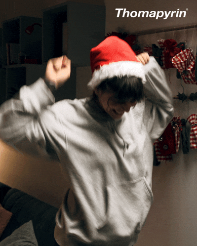 a person wearing a santa hat with the word thomapyrin on the bottom right