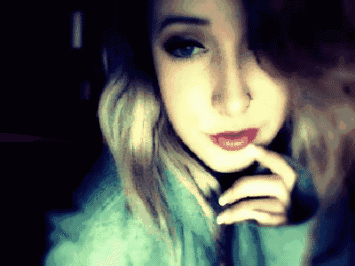 a close up of a woman 's face with blue eyes