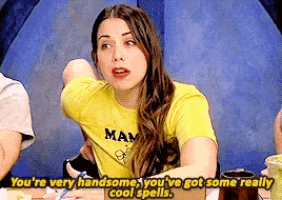 a woman wearing a yellow shirt that says " you 're very handsome you 've got some really cool spells "