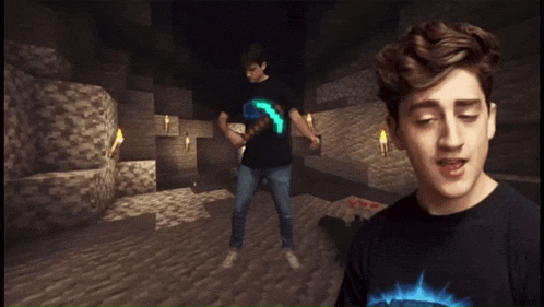 a boy in a black shirt with the word minecraft on it stands in a cave