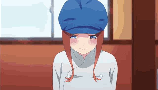 a girl with red hair is wearing a blue hat and a white shirt .