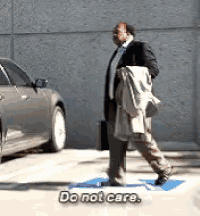 a man in a suit and tie is walking towards a car and says do not care .