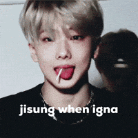 a young man with a lollipop sticking out his tongue and the words jisung when igna