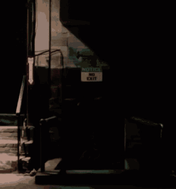 a sign that says notice no exit is in the dark
