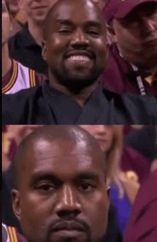 a man with a beard is smiling in front of a crowd