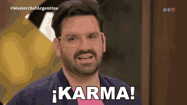 a man with glasses and a beard says karma in spanish