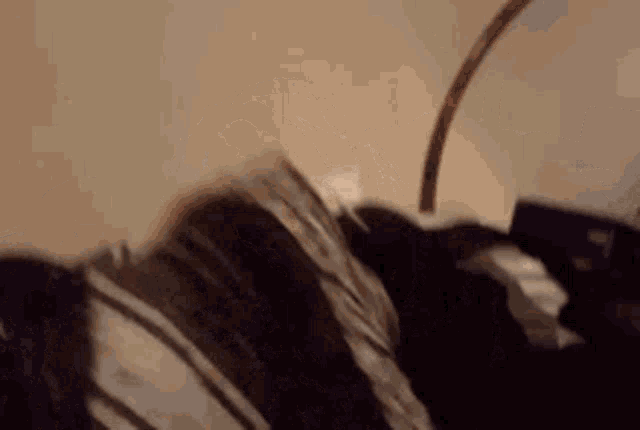 a person is laying on a bed with a lamp on their head .
