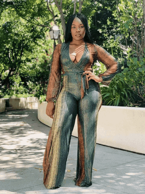 a woman wearing a jumpsuit with a plunging neckline