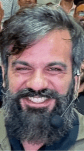 a man with a beard and mustache is smiling