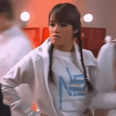 a woman wearing a white jacket and a white shirt with the letter n on it