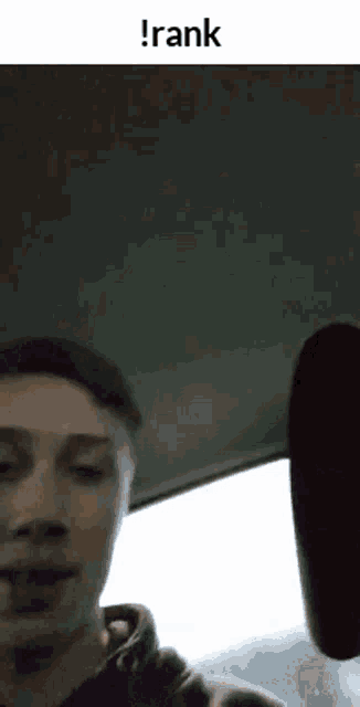 a man is sitting in the driver 's seat of a car and talking to the camera .