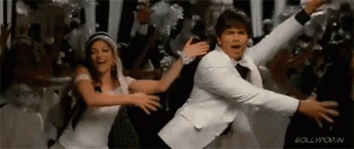 a man and a woman are dancing in front of a crowd of people at a party .