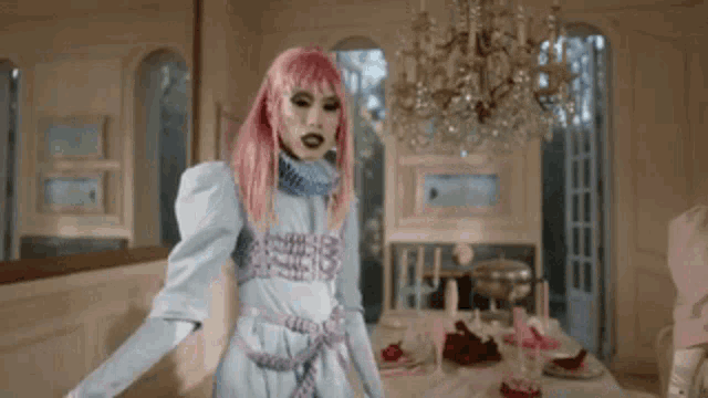 a woman with pink hair is dancing in a room
