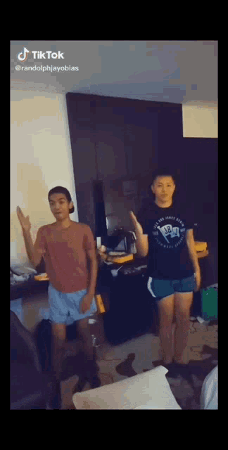two people are dancing in a room with a tik tok watermark
