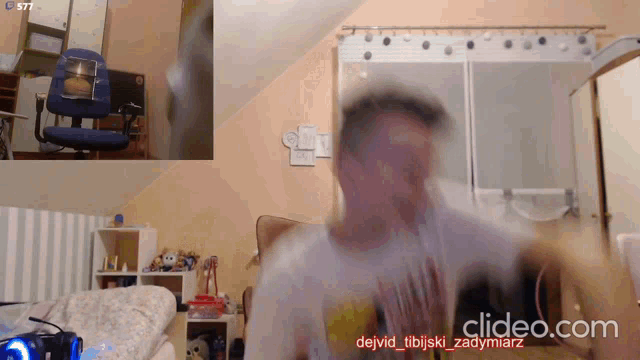 a blurry picture of a man in a room with the words clideo.com below him