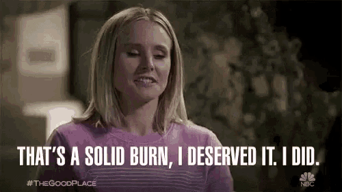 a woman in a pink sweater is saying `` that 's a solid burn , i deserved it