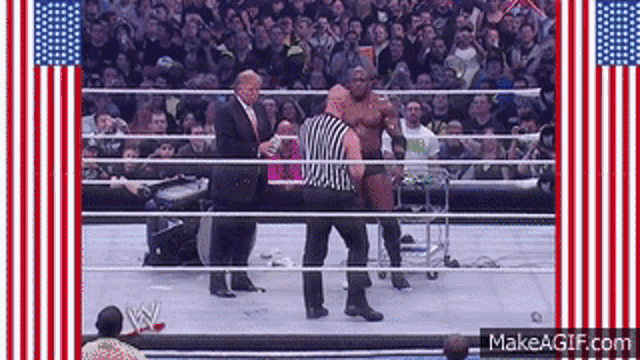 a man in a suit and tie stands in a wrestling ring