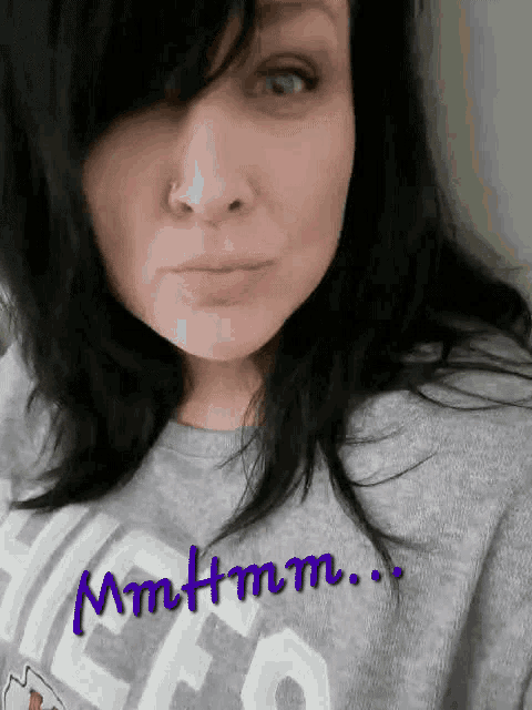 a woman wearing a gray shirt with the word chicago on it