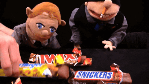 two snickers candy bars are being eaten by two puppets